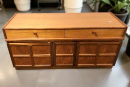A Nathan teak low sideboard, fitted drawers and cupboards beneath, 130 cm x 46 cm x 66 cm.