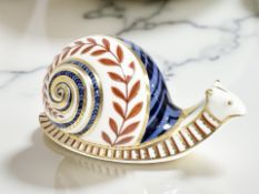 A Royal Crown Derby Snail paperweight, with gold stopper, length 12.