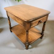 An Ercol stained elm single drawer rectangular occasional table, length 67 cm.