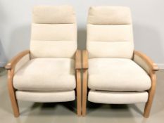 A pair of light elm manual reclining lounge armchairs, width 70 cm.