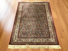 A machine made rug of Iranian design, 213 cm x 145 cm.