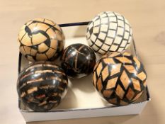 A group of lacquered carpet bowls and a jack.
