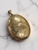 A 9ct yellow gold locket pendant with floral engraved case, 50 mm x 40 mm.