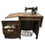 A Singer electric sewing machine in oak table.