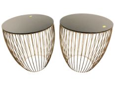 A pair of contemporary painted metal and ebonised drum tables, height 50 cm.