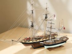 Two scale model ships, the largest 103 cm long.