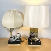 Two contemporary table lamps surmounted by dogs, the larger 64 cm high including shade.