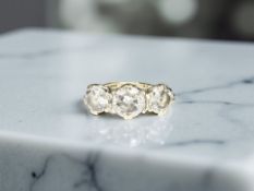 A 9ct gold three stone dress ring, size K CONDITION REPORT: 4.