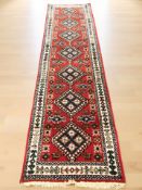 An Iranian woolen runner, 310 cm x 84 cm.