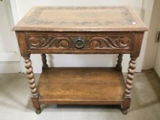 An Edwardian carved oak single drawer side table on barley twist supports, width 76 cm.