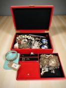 A jewellery box containing a heavy white metal bangle, rings, charms, earrings, necklaces, trinkets,