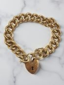 A heavy-gauge 9ct yellow gold solid link bracelet with heart padlock CONDITION REPORT: