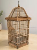 A contemporary Chinese wooden hexagonal bird cage, height 80 cm.