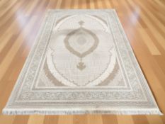 A machine-made carpet of Tabriz design,