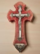 A velvet and silvered metal crucifix,