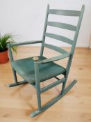A 20th century painted ladder back rocking chair, width 63 cm.