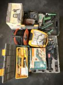 A collection of power tools and hardware including a Ryobi reciprocating saw, a Hitachi nail gun,