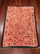 An embroidered and sequined eastern style throw, approximately 160 cm x 107 cm.