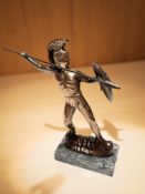 A patinated metal figure of a Roman warrior,