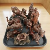 A group of hardwood oriental figures and ornaments including water buffalo, elephants,
