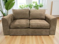 A contemporary three seater settee in light brown suede fabric, length 193 cm.