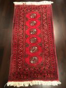 A Turkoman rug, Afghanistan, 110 cm x 56 cm.