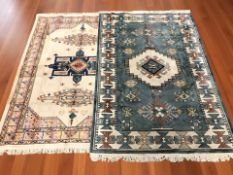 A machine made carpet of Caucasian design, 203 cm x 133 cm, and another similar, 200 cm x 140 cm.