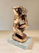 A reproduction patinated metal figure of Venus,