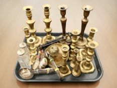 A group of Victorian brass candlesticks and silver plated cutlery