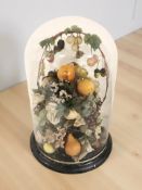 A 19th century arrangement of waxed fruit under glass dome, on circular base,