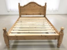 A contemporary pine 4 ft 6 bed frame.