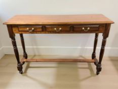 A reproduction mahogany three drawer hall table, 134 cm x 37 cm x 87 cm.