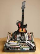 A quantity of Playstation 2, Xbox 360 and other video games, controllers, Guitar Hero guitar, etc.