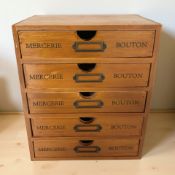A five drawer wooden storage chest
