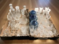 Two boxes of crystal and glass wares, coloured glass storage jars,
