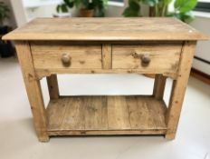 A rustic pine two drawer side table with under shelf, width 108 cm.