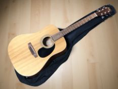 An Encore Model EA4OON acoustic guitar with a soft carry bag.