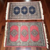 A Lahore Bokhara rug, Pakistan, 108 cm x 63 cm, together with another similar rug.