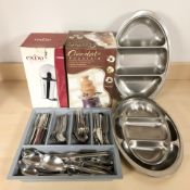 A group of stainless steel kitchen utensils,