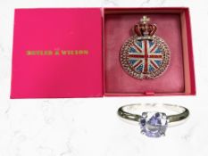 A silver and tanzanite solitaire ring, size K½, and a Butler & Wilson brooch in box.