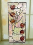 A stained and leaded glass panel,