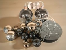 A contemporary hanging wall light and a pair of ceiling lights