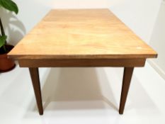 A 20th century teak extending dining table with internal leaf, unextended 152 cm x 84 cm x 72 cm.