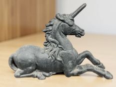 An early 20th century cast iron boot scraper in the form of a unicorn, width 62 cm.