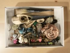 A group of miniature trinkets, clock keys, miniature eggs,