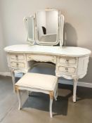 A cream and gilt kidney shaped mirror back dressing table, width 137 cm,