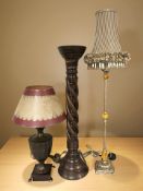 A hardwood barley twist pricket candle stand, height 73 cm, and two table lamps.