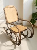 A bentwood and caned rocking chair, width 52 cm.