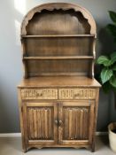 A Dutch style oak linen fold dresser, 96 cm x 46 cm x 178 cm.