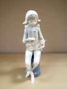 A Nao by Lladro 0381 harlequin jester clown boy with cat, height 13 cm.